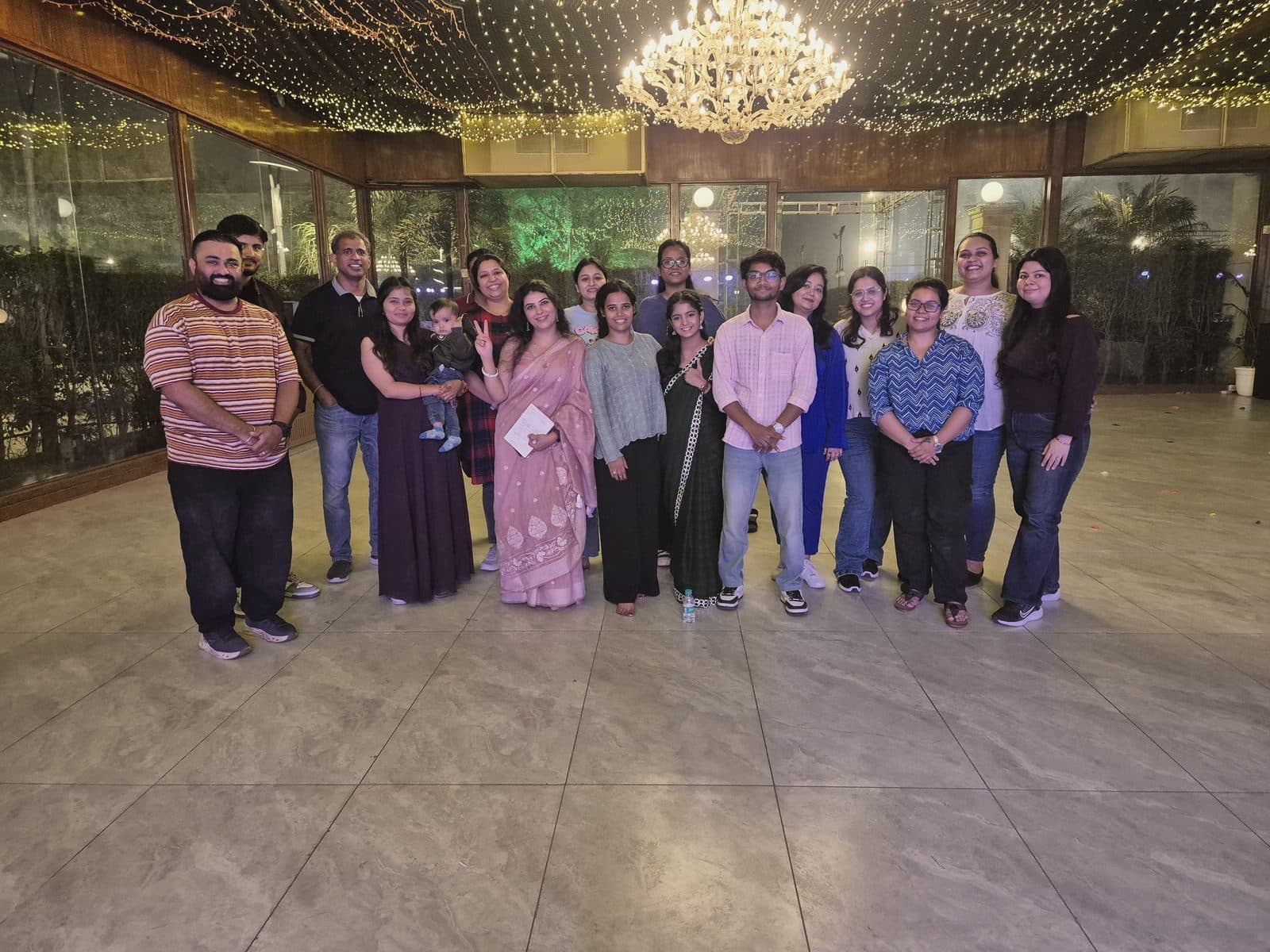 A corporate team in a chandeliered banquet hall