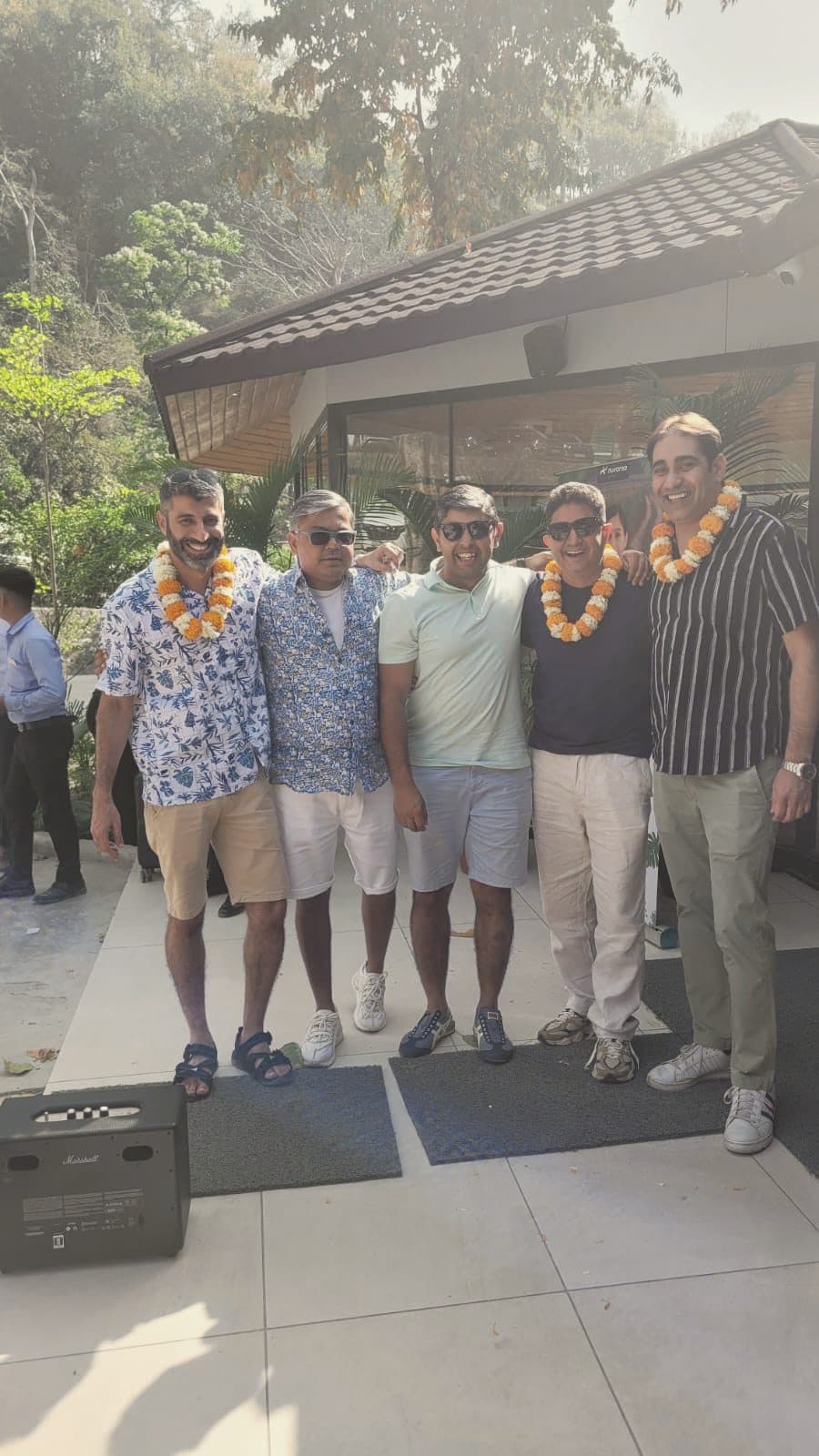 A group garlanded on arrival at a resort
