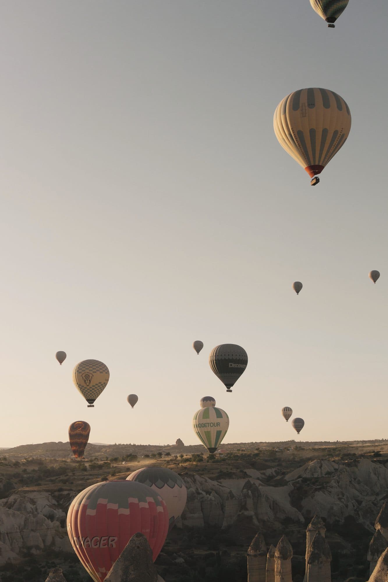 Hot-air balloons rising over Cappadocia at dawn