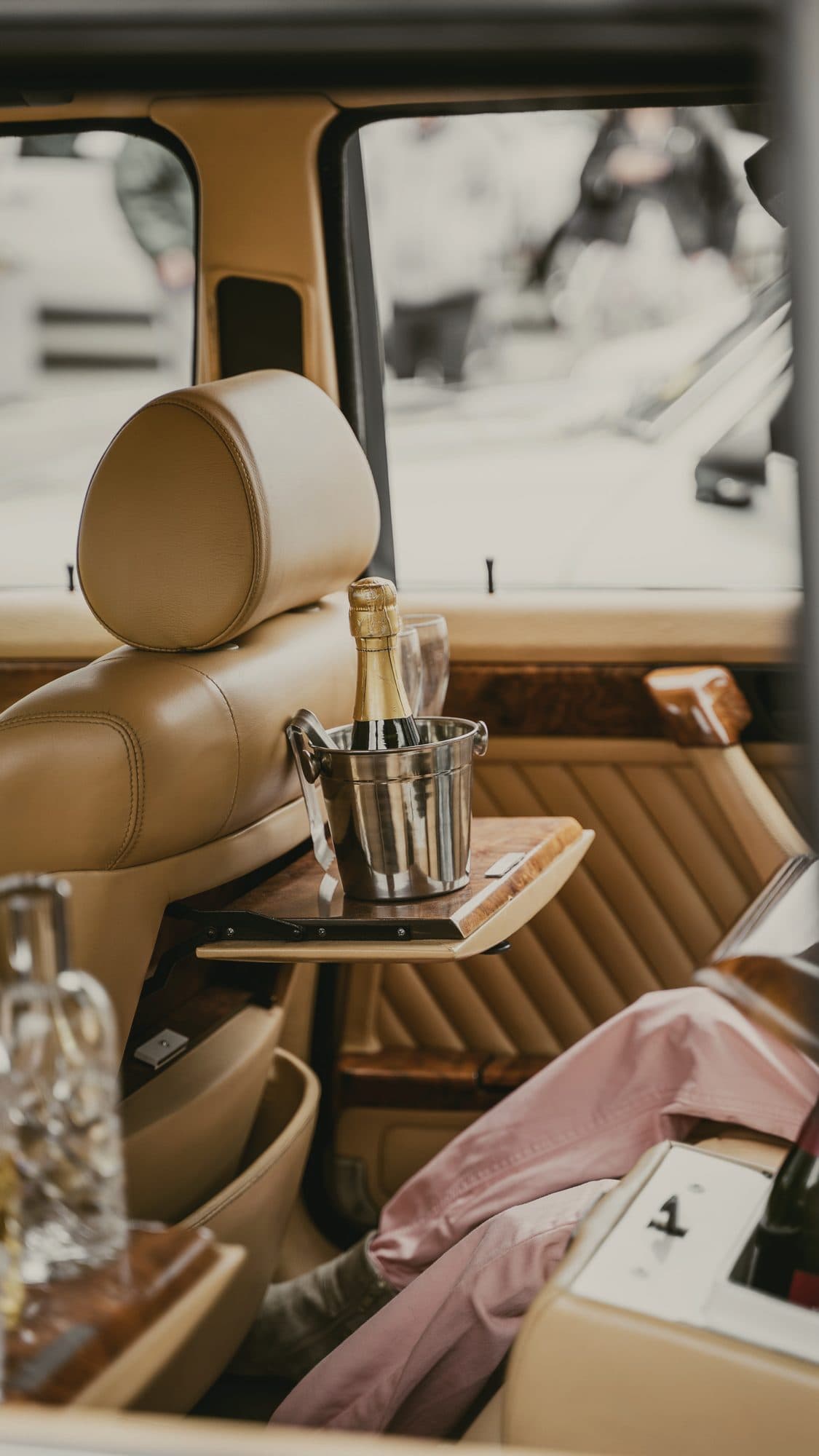 Champagne on ice in the back of a classic car with leather seats